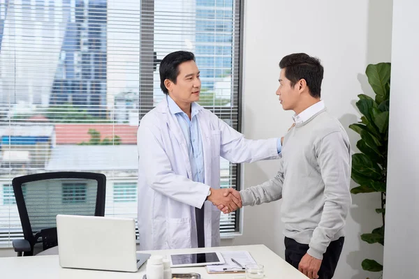 Smiling medical doctor with  man. Health care.