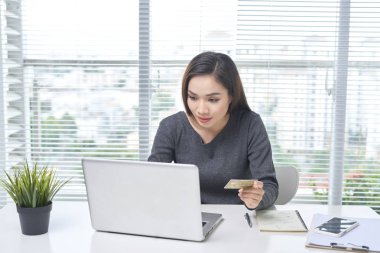 Bir masada oturan güzel bir bayan. Büro hayatı. İş yerinde.