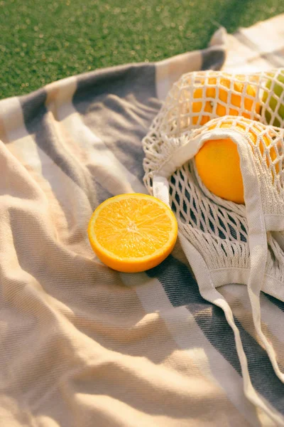 Fruit net bag on the plaid in the field