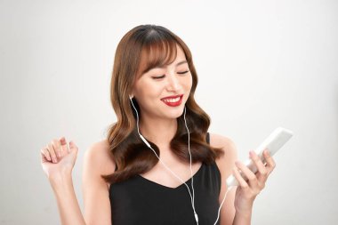 Mutlu Asyalı Kadın kulaklıkla müzik dinliyor. Genç Asyalı kadın model.