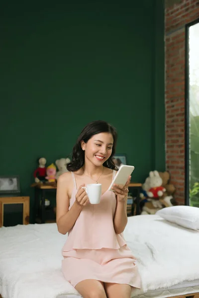 Relaxed Young Woman Sitting Bed Cup Coffee Cellphone — Stock Photo, Image