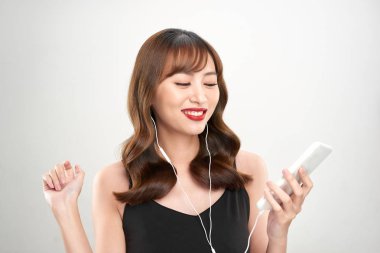 Mutlu Asyalı Kadın kulaklıkla müzik dinliyor. Genç Asyalı kadın model.