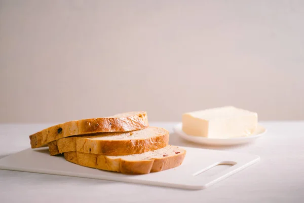 白いテーブルに焼きたてのパンと自家製バター — ストック写真