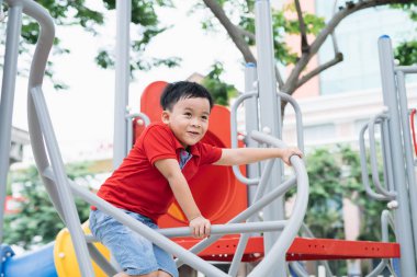 Çocuk oyun alanı üzerinde tırmanma mutlu küçük çocuk