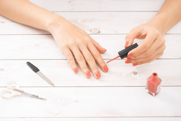 Nail care and manicure. Beautiful female hands with nail polish. Red manicure