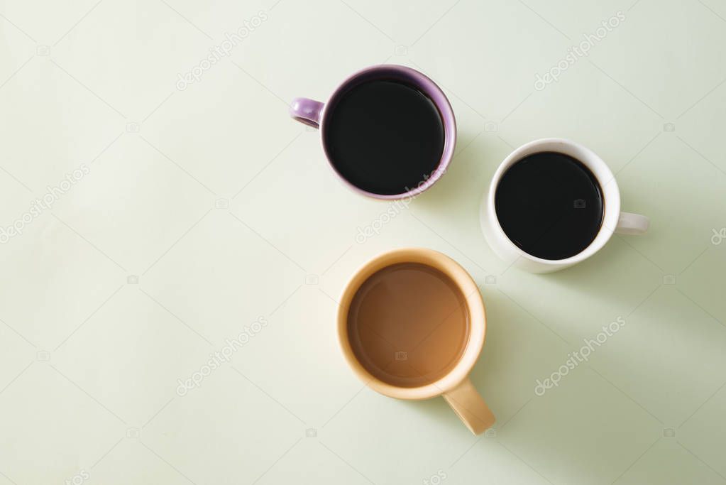 Cups of coffee on light background