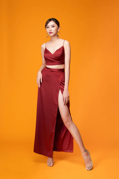 Full length portrait of young sexy woman in red dress  standing 