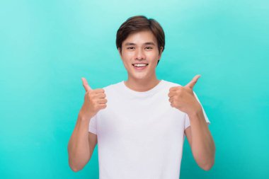 Attractive successful smiling man with thumb up. clipart