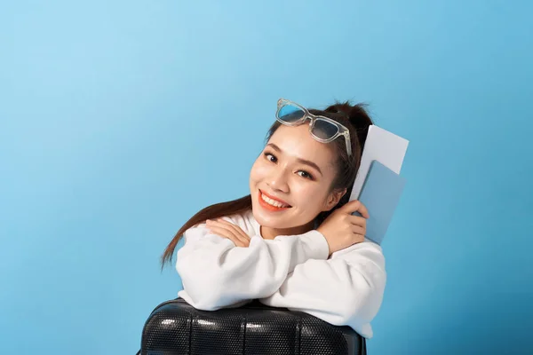 Young Asian Woman Sitting Suitcase Holding Passport Blue Background — Stock Photo, Image