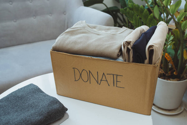 Donation box and casual clothes in livingroom