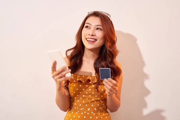 Portrait Happy Girl Holding Mobile Phone Credit Card Isolated Biege — Stock Photo, Image