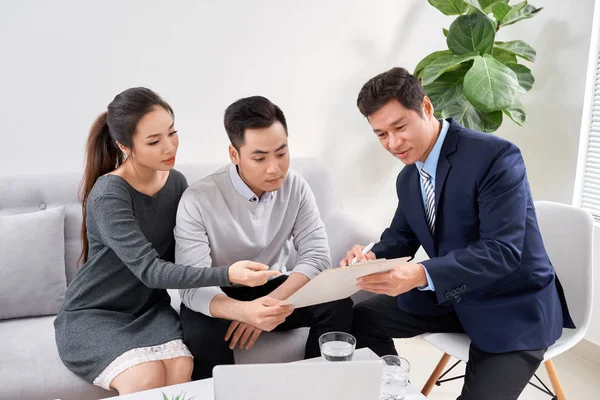 Sales Consultant Toont Nieuwe Investeringsplannen Aan Jong Aziatisch Koppel — Stockfoto