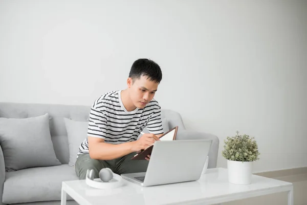 Handsome Young Man Sitting Living Room Couch Writing Some Notes — Stock Photo, Image