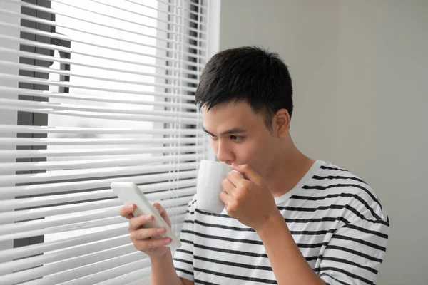 Smiling Handsome Young Man Using Phone Window — Stock Photo, Image