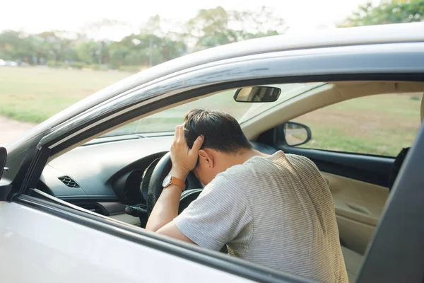 Illness, exhausted, disease, tired for overworked concept. Asian businessman having headache from migraine while he driving car.