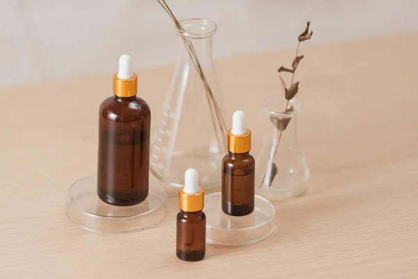 Cosmetic bottle stock images. Brown cosmetic bottle with batcher. Vials on a white background