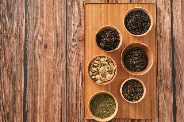 Assortment Dry Tea White Bowls Wooden Surface — Stock Photo, Image