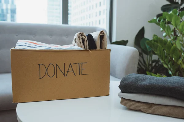 Donation box and casual clothes in livingroom