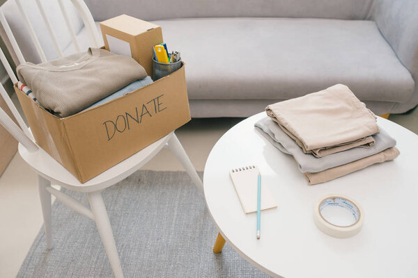 Donation box and casual clothes in livingroom