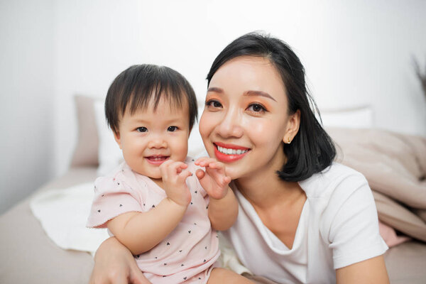 Cute little girl sitting in a room. Child have fun at home.