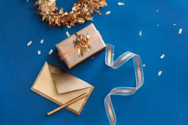 Gouden envelop, vak, lint met krans gemaakt van kerst decorat — Stockfoto