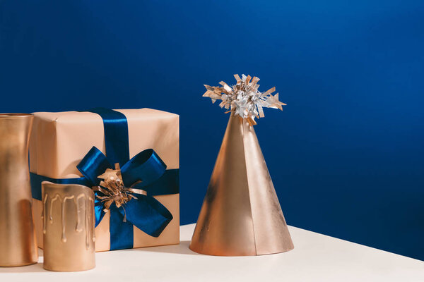 Christmas party hat with gift box on blue background
