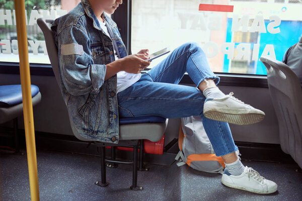 Transport. People in the bus. He reading book in transport.
