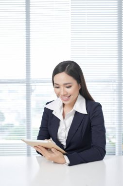 İş kadını ofiste belgeleri inceliyor.