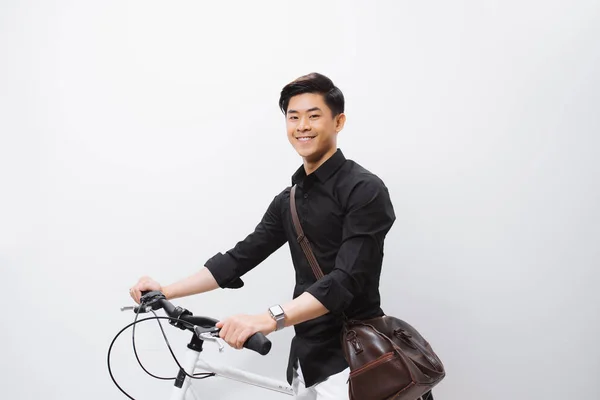 Handsome guy standing by bicycle isolated on white