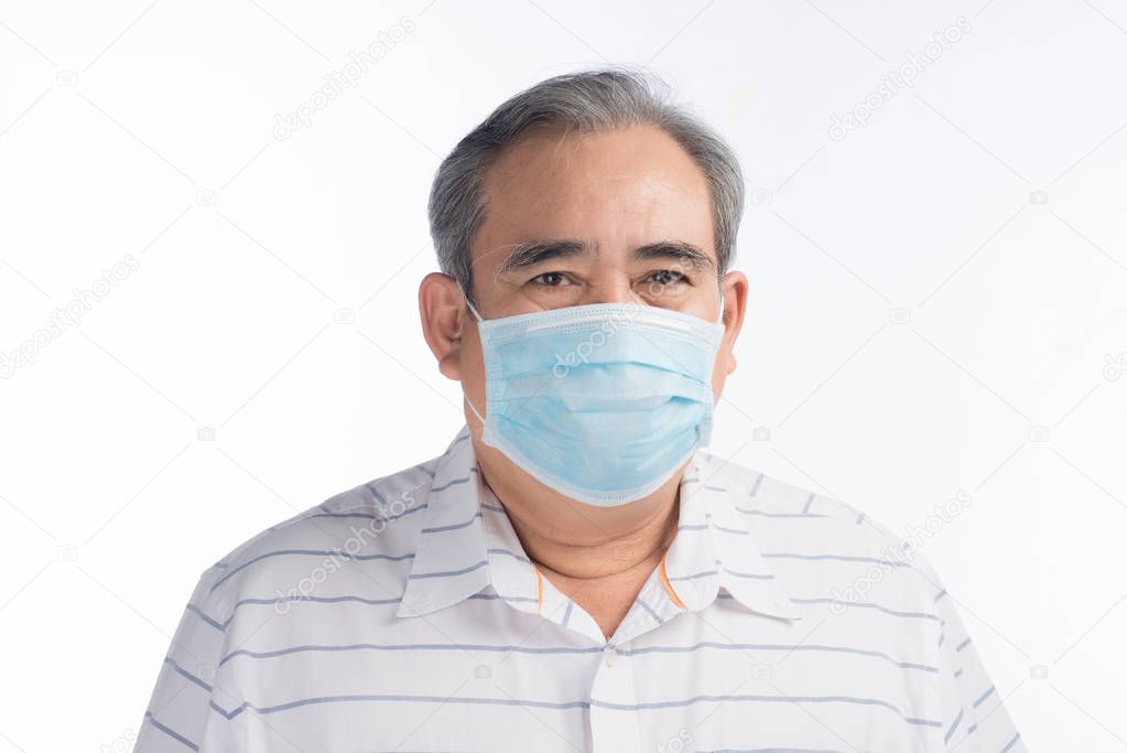 Asian senior man wearing face mask isolated on white background, selective focus.