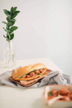 Banh Mi Xiu Mai - Domates soslu Vietnam sandviçi, chua (turp ve havuç turşusu), salatalık ve kişniş.