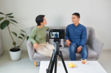 Asian couple blogger enjoy communication lives with camera house background concept