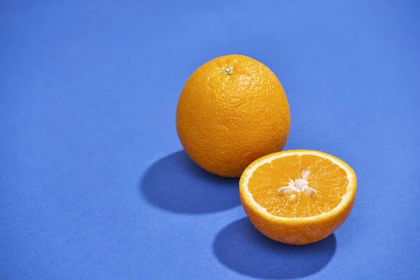 orange with half of orange isolated on the blue background