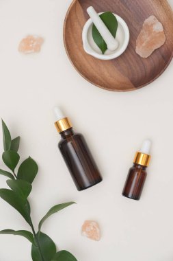 Top view. Essential oil in brown bottles with herbal, message salt on white background. Spa/ beauty product concept. clipart