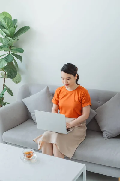 Smiling Woman Sitting Sofa Relaxing While Browsing Online Shopping Website — Stock Photo, Image
