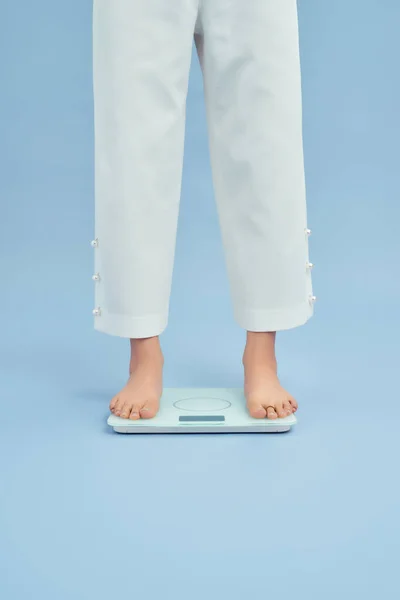 Legs of women standing on scales weight. Concept of health and weight loss.