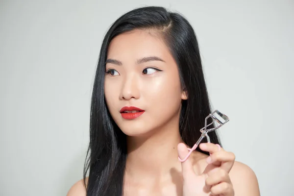 亚洲女人用卷发钳矫正睫毛 — 图库照片