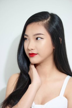 Şenlikli makyajlı, düşünceli, genç, siyah saçlı bir kadının stüdyo fotoğrafı. 