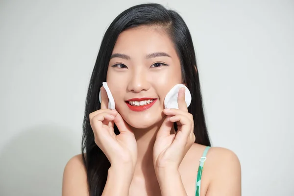 漂亮漂亮的年轻亚洲女人用棉垫在白色孤立的背景上清洁她的脸 健康皮肤和化妆品概念 — 图库照片