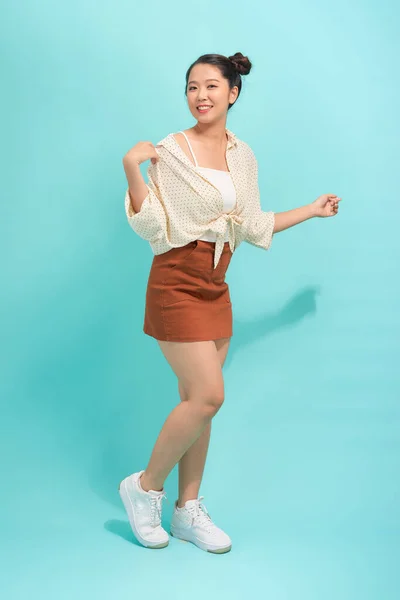 Full Length Portrait Cheerful Young Woman Jumping Celebrating Blue Background — Stock Photo, Image