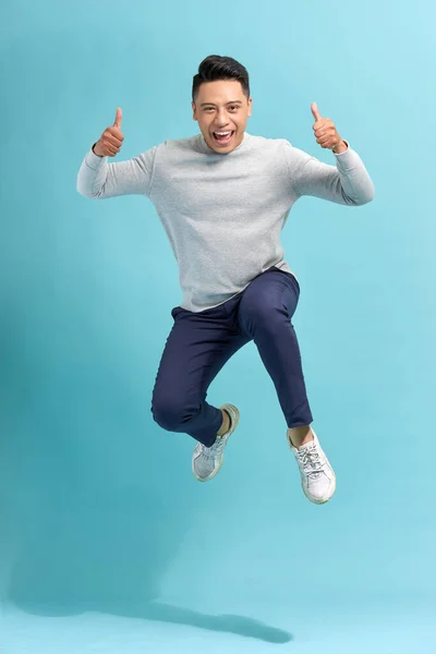 Overjoyed Guy Jumping Showing Thumbs Blue Studio Background — Stock Photo, Image
