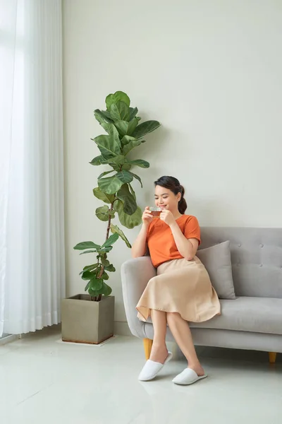 Portrait Smiling Young Woman Tea Cup Sitting Couch Home — Stock Photo, Image