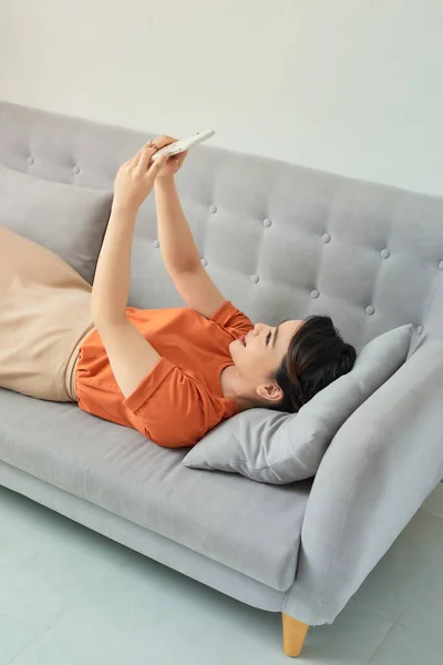 Mujer Feliz Usando Teléfono Móvil Sofá —  Fotos de Stock