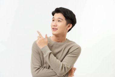 Mutlu gülümseyen Asyalı adamın izole edilmiş portresi, elini boş alanı işaret ediyor stüdyo dışında beyaz arka plan.