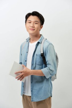 Sırt çantalı, sırtüstü sırtüstü gülümseyen genç bir öğrenci beyaz arka plan stüdyo resmine izole edilmiş. Lise üniversite konsepti eğitimi. 