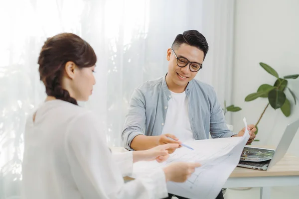 Man Vrouw Architect Bespreken Een Set Blauwdrukken Verspreid Een Tafel — Stockfoto