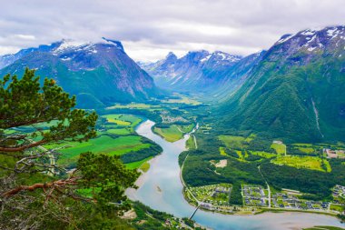 Panoramic landscape Andalsnes city located on shores of Romsdalsfjord (Romsdal Fjord) between the picturesque mountains. View from Rampestreken Viewpoint in Andalsnes city. Rauma Municipality, Norway. clipart