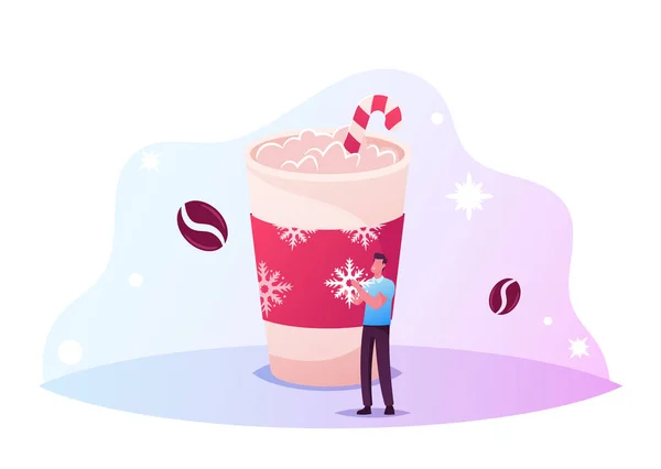 Kleine mannelijke karakter versieren Enorme kop koffie met sneeuwvlokken voor kerstvakantie. Man stand bij wegwerp mok — Stockvector