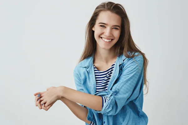 Waist-up studio shot charming tender feminine girlfriend laughing out loud showing happiness positive optimistic attitude pressing palms together silly flirty grinning camera, white background