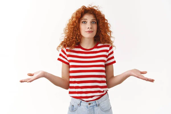 No idea sorry. Perplexed awkward redhead curly woman summer striped t-shirt shrugging hands sideways pursing lips uncertain cannot answer standing questioned clueless, confused what happened